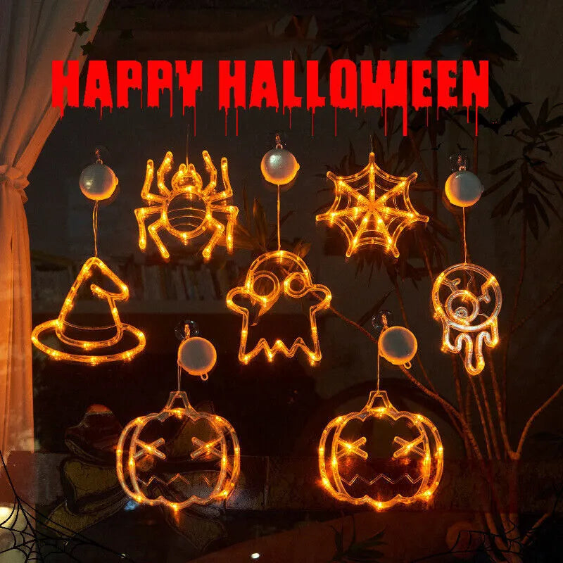 Halloween battery-powered LED window lights with spider, pumpkin and ghost figures hung by suction cups.