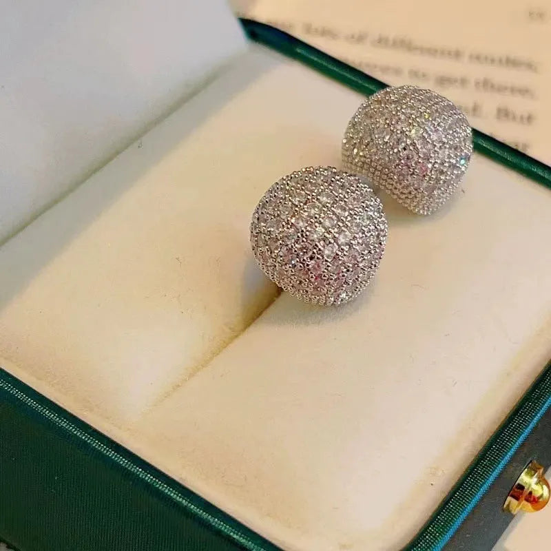 Gold and white drop-shaped geometric ear clip earrings with full diamond detailing and sphere elements