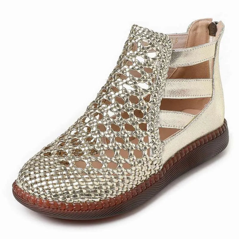 Gold flat sandals with round toe and breathable hollow-out design on a white background.