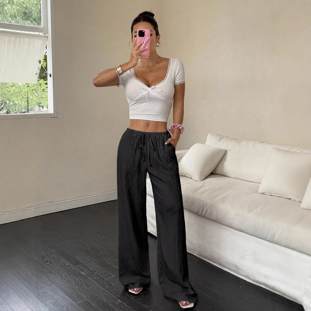 Women's black wide-leg trousers with a front lace-up waist detail on a mid-waist.