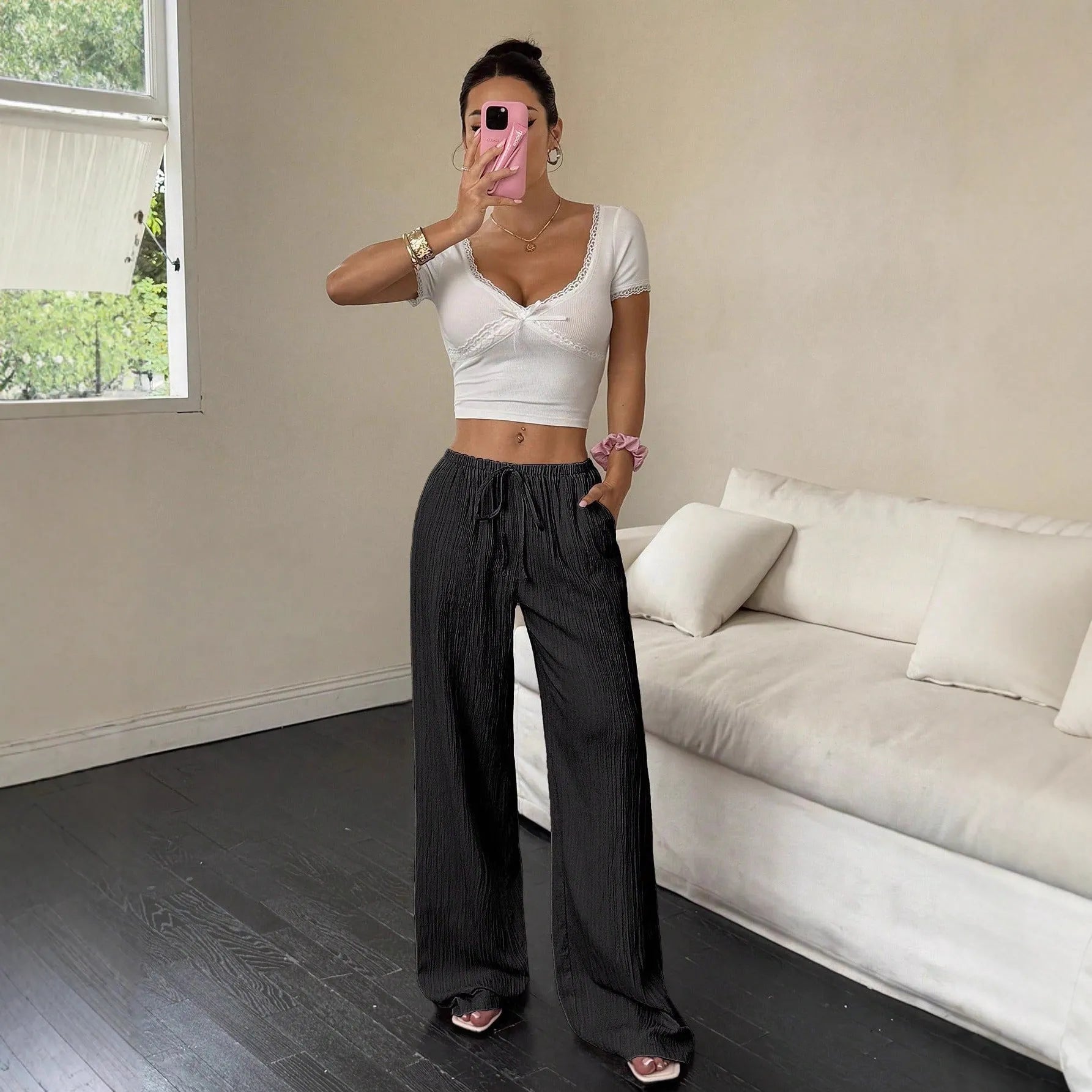 Women's black wide-leg trousers with a front lace-up waist detail on a mid-waist.