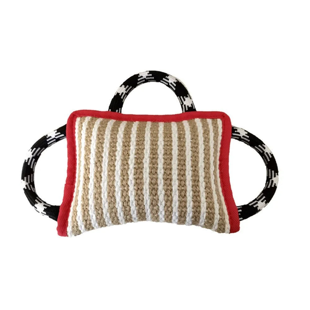 Dog tug of war toy with blue jute bite pillow and three rope handles on a wooden floor.