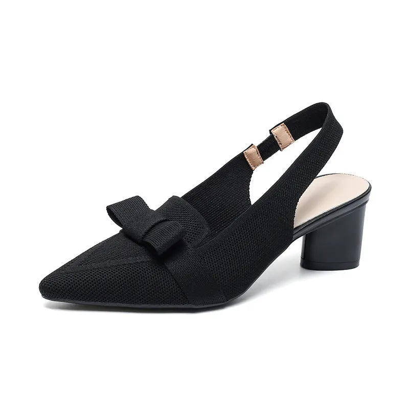 Women's black closed toe high heel sandals with a bow detail and an ankle strap on a rubber sole.