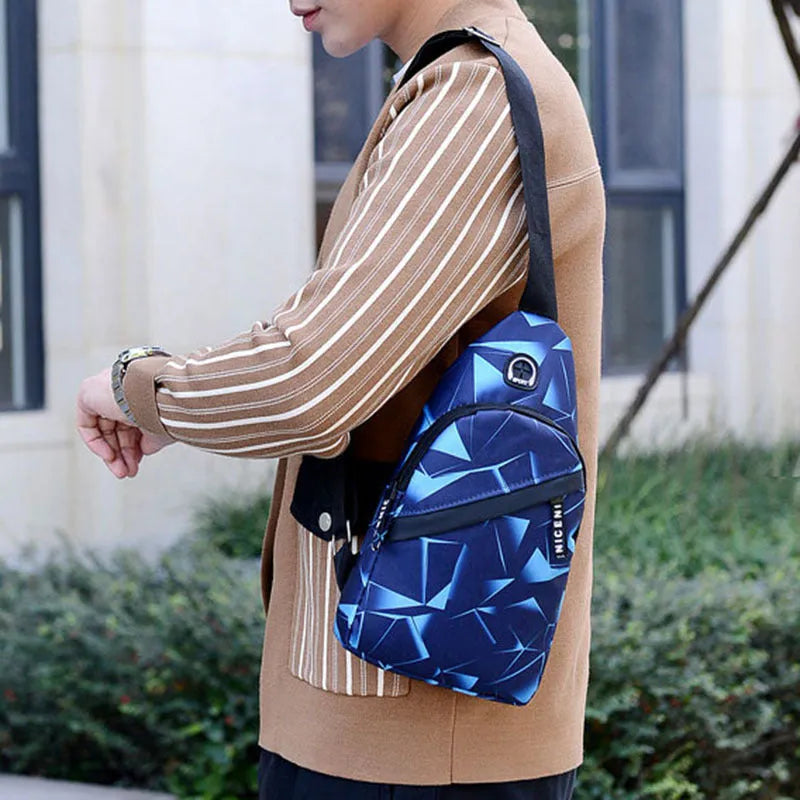 Blue men's crossbody sling bag with earphone hole, made from Oxford cloth, showing front zipper and strap.