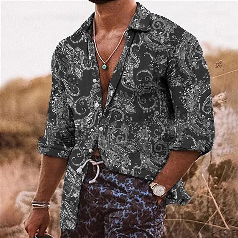Man wearing a loose-fit bohemian shirt with a colourful 3D floral print pattern, long sleeves.
