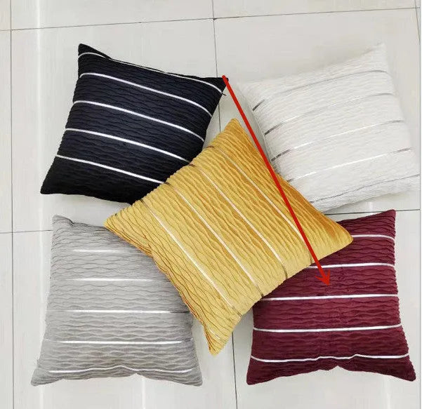 Soft striped velvet pillow cover for a sofa cushion in silver grey colour, shown on a chair.