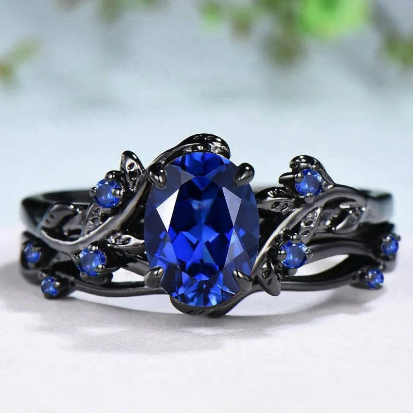 Gun black geometric copper women's ring with an inlaid navy blue rhinestone, shown in size 10.
