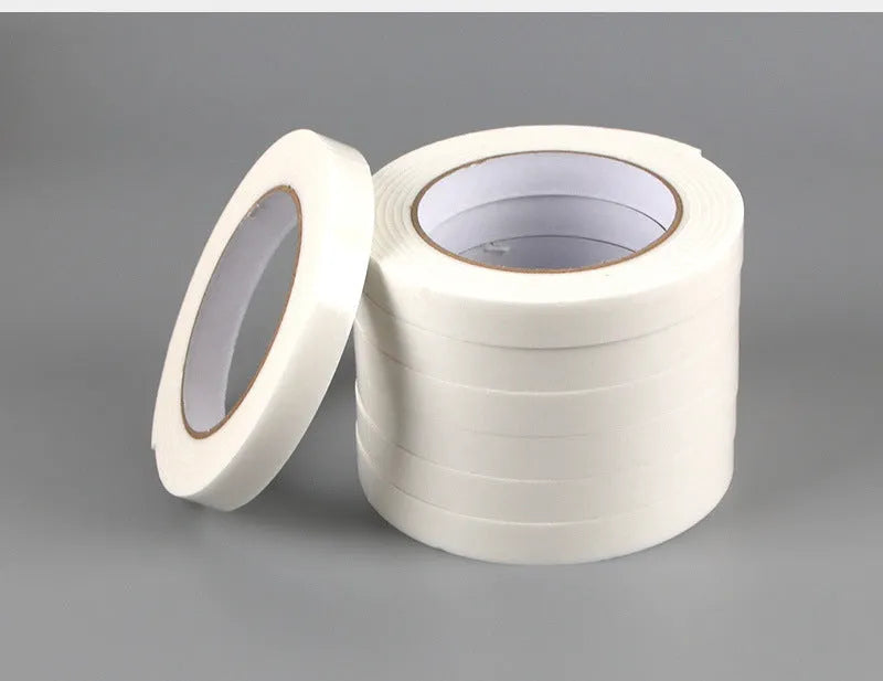 Roll of white foam double-sided adhesive tape showing its 3mm thickness and strong adhesive.