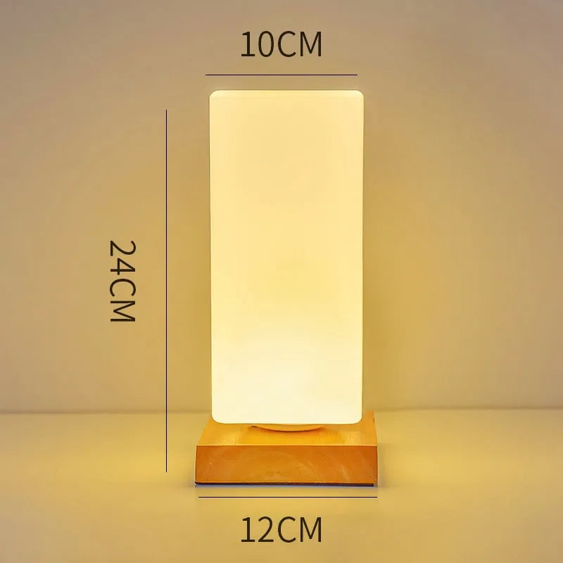 Nordic style solid wood USB table lamp in a cube shape with touch dimming on a wooden desk.