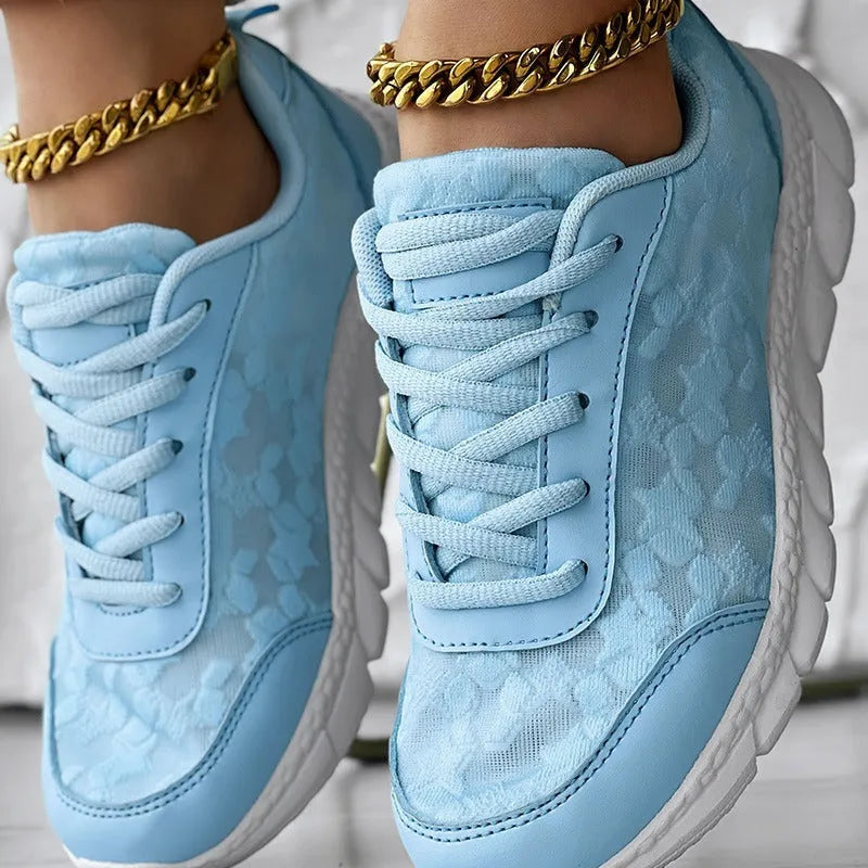 Women's white canvas casual running shoes with flat sole on a light background.
