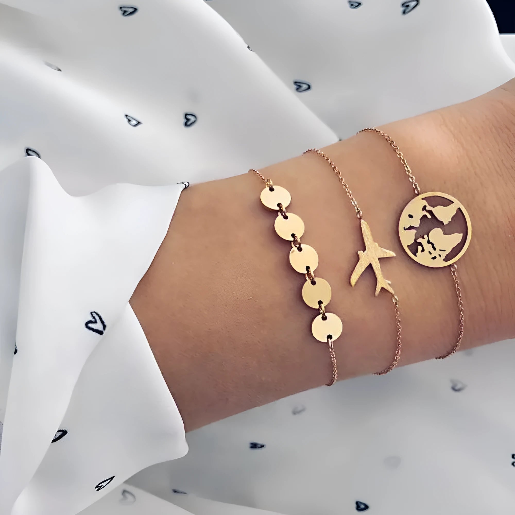 Set of three women's bohemian bracelets with heart-shaped aircraft map charms in alloy.