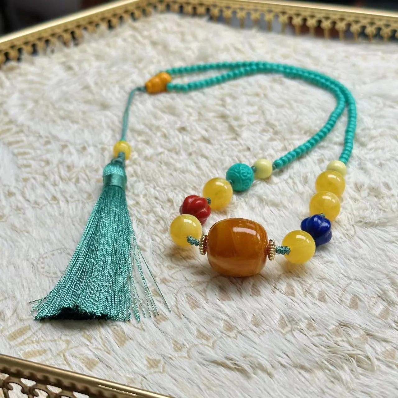 Hand-woven turquoise mesh flower lucky pendant on an adjustable ball bead necklace.