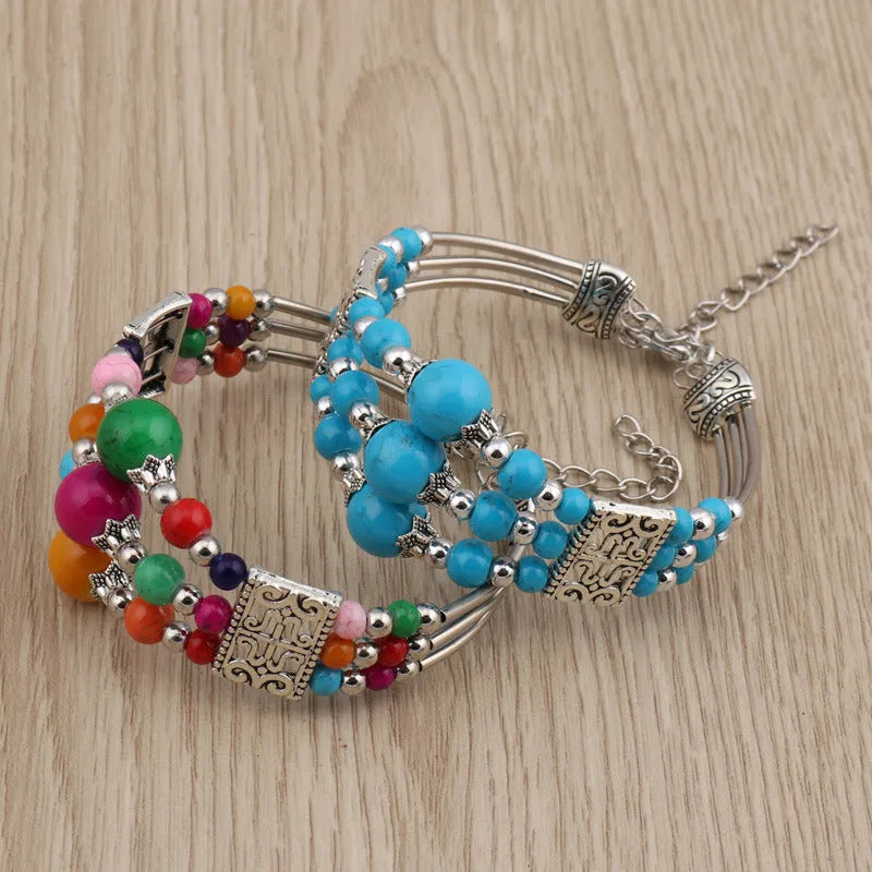 Tibetan style wide bangle bracelet with colourful beads, turquoise tone, tassel detail and electroplated alloy finish