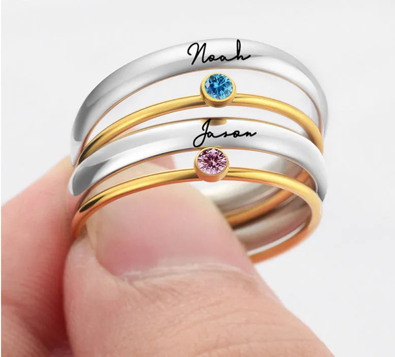 Engraved December birthstone ring in titanium steel with geometric shape on a grey background.