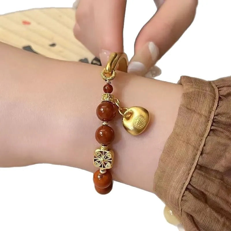 Golden south red agate character ingot bracelet handmade from glass and coloured glaze
