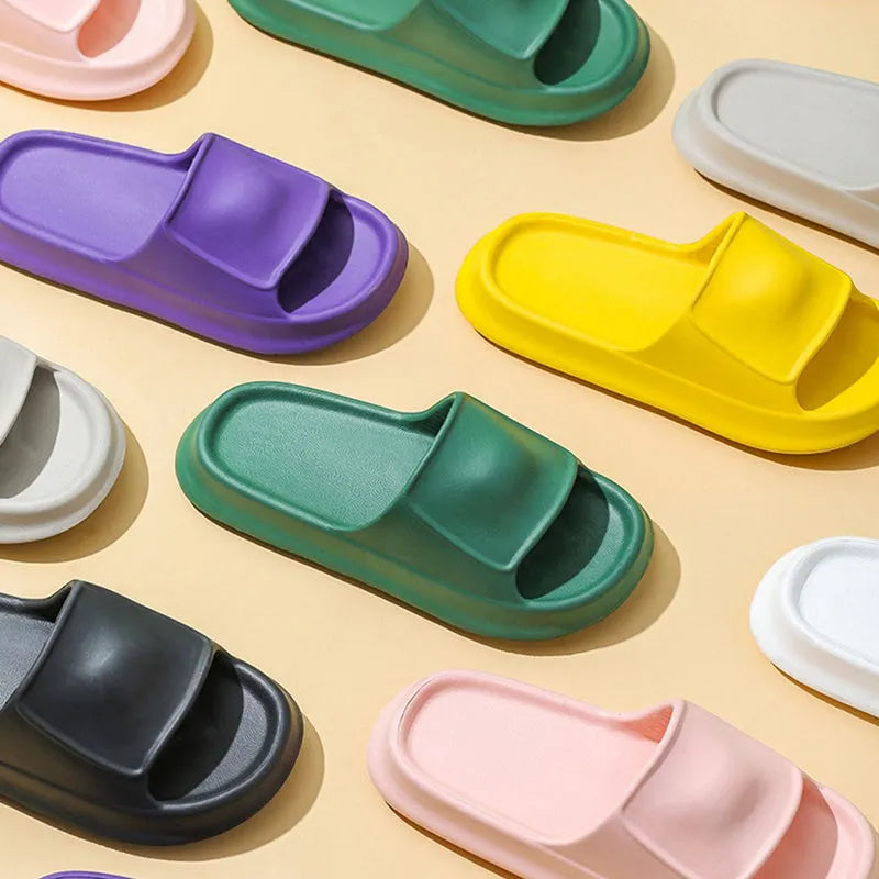 Pair of thick-soled white EVA flip-flop slippers with a non-slip patterned sole.