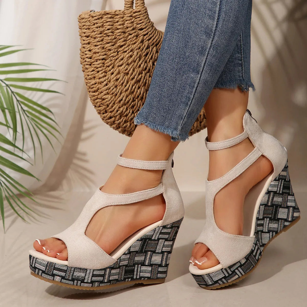 Women's beige ankle-strap sandals with a buckle and thick, textured rubber soles on a plain background.