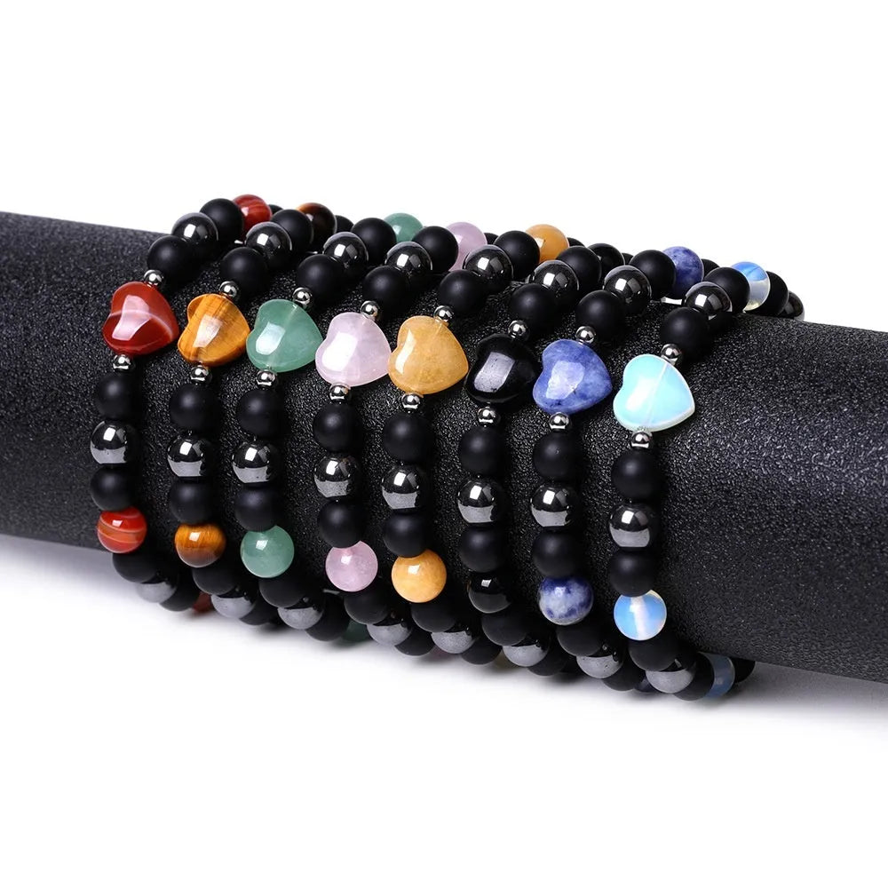 Hand-cut stone peach heart bracelet in Tigereye with geometric design and celestial moon planet motifs