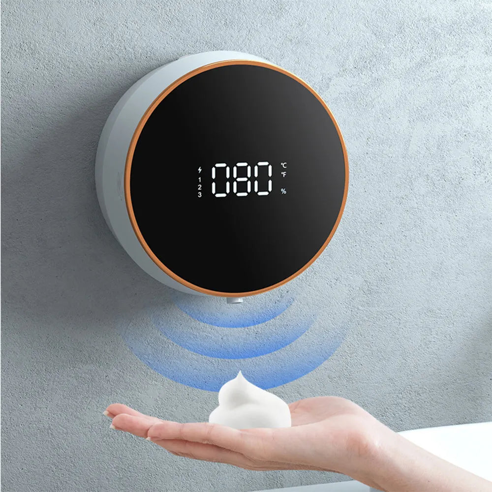 Black and white automatic sensor foam soap dispenser mounted on a wall with USB charging cable.