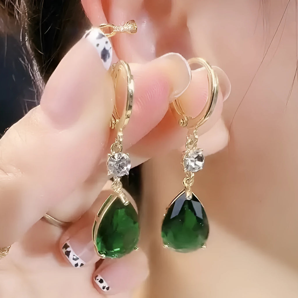 A pair of green geometric teardrop-shaped alloy fashion earrings on a plain background.
