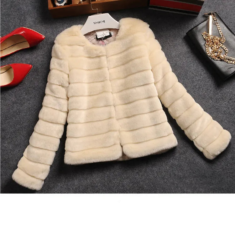 Woman wearing a short white faux fur top with regular sleeves, styled with jeans.