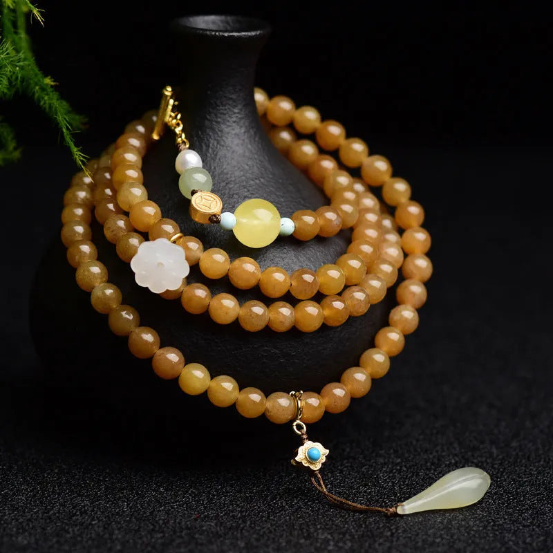 Green pine jade bracelet with 6mm round beads, leaf charms, and sequin accents on wrist
