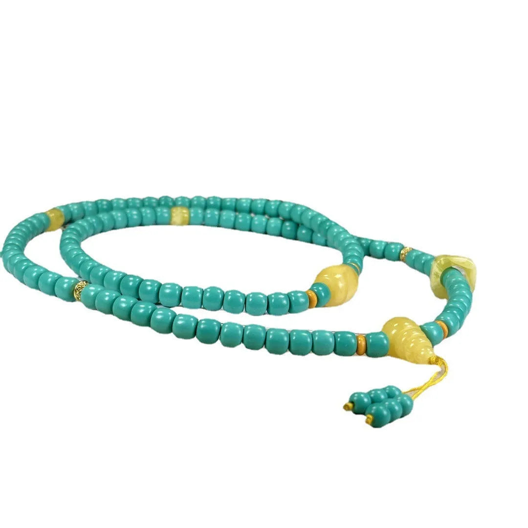 Hand-woven turquoise mesh flower lucky pendant on an adjustable ball bead necklace.