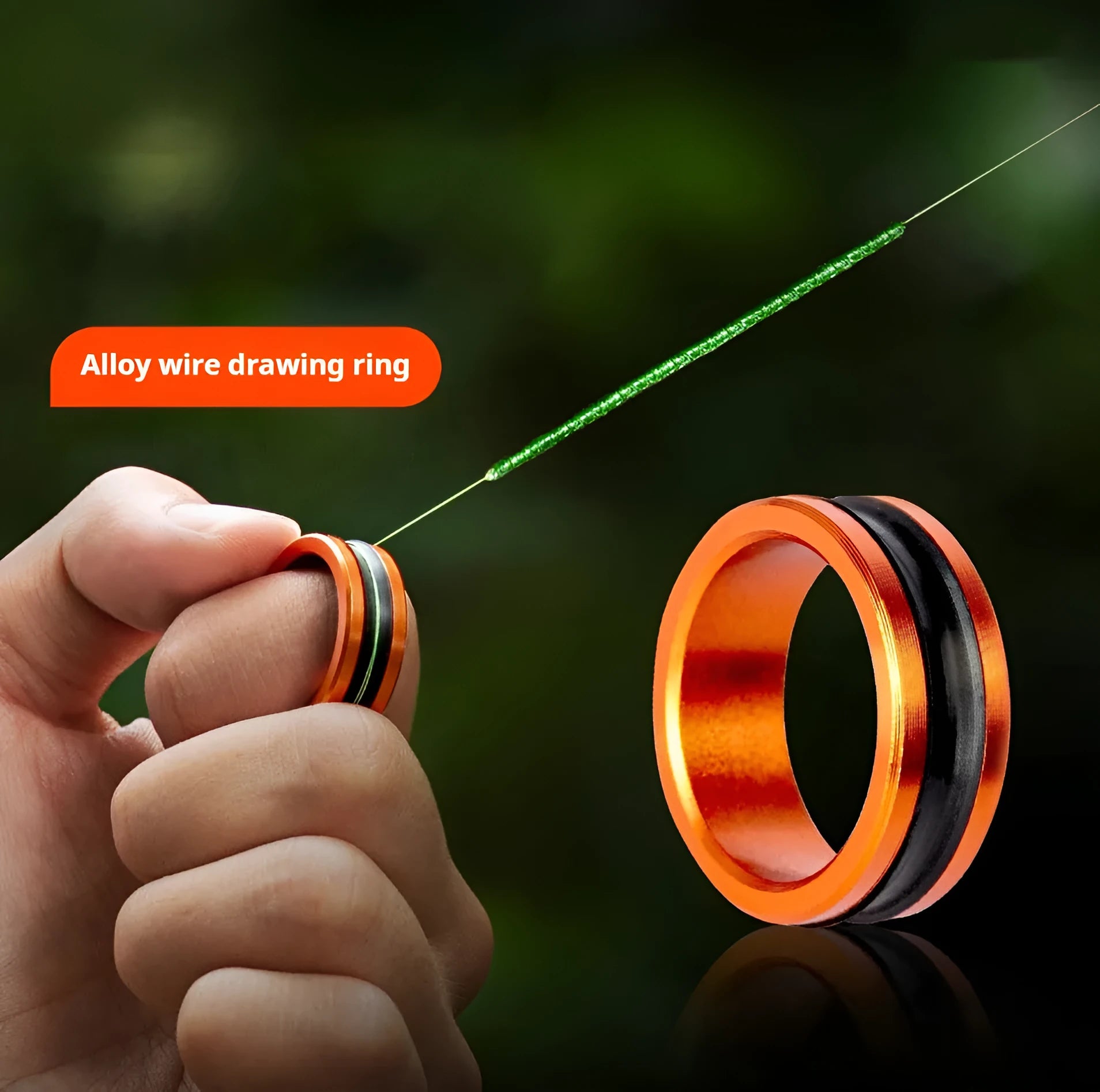 Orange and silver alloy non-slip fishing hand guard pull loop tool on a plain background.