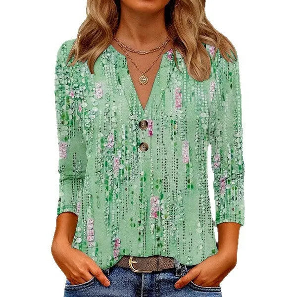 Woman wearing a loose-fit grey V-neck top with a raised white 3D geometric pattern on the front.