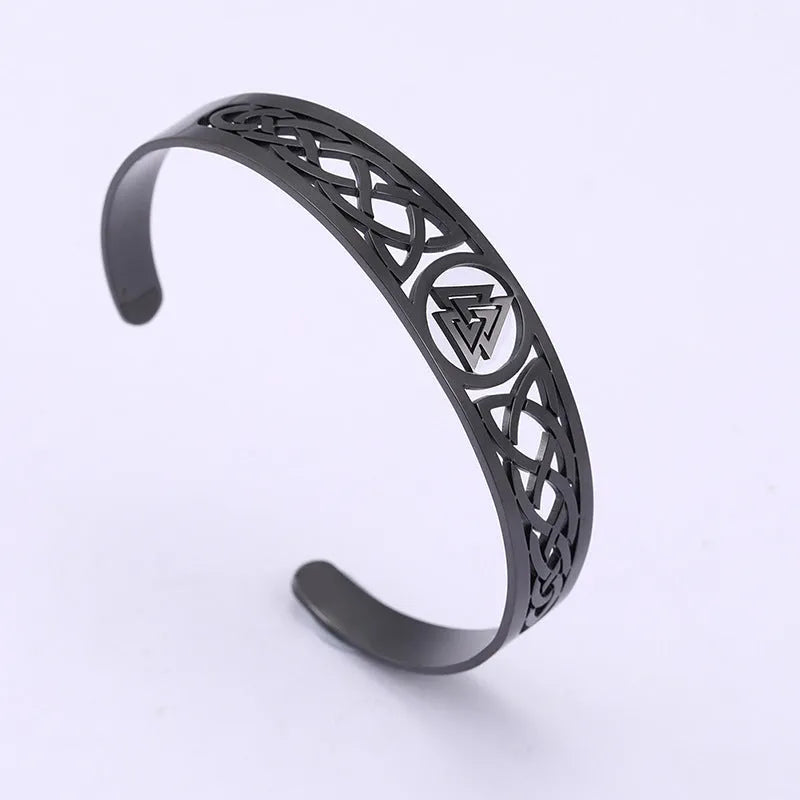 Handcrafted stainless steel bracelet with Valknut symbol and Celtic design on a neutral background