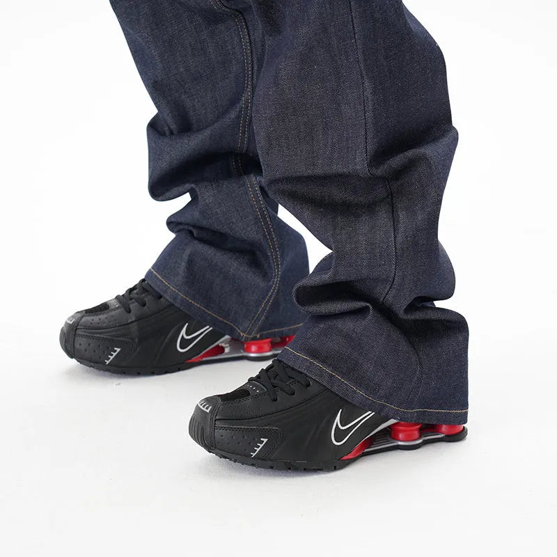 Dark blue loose straight-leg casual jeans on a neutral background.