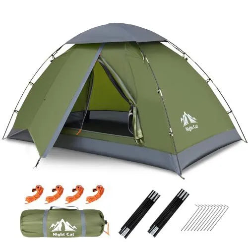 Dark green automatic pop-up tent set up in a field, showing its compact two-person size and instant design.