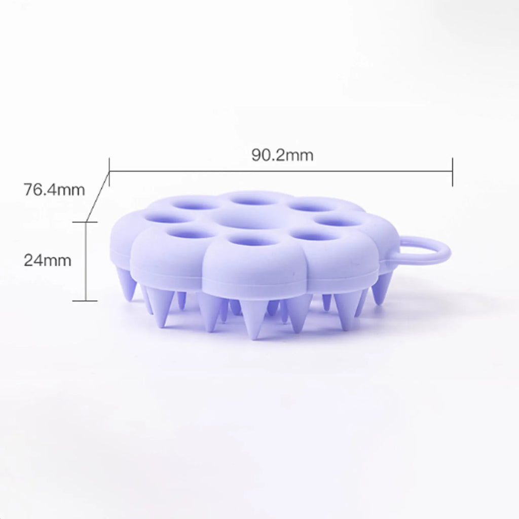 Silicone pet grooming brush with ergonomic handle shown in blue, for use on dog or cat coat during dry grooming or bath.