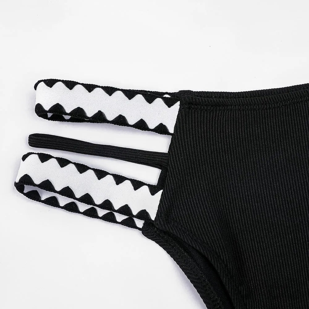 Black women's hollowed-out split swimsuit bikini set on mannequin