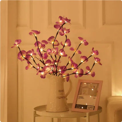 A 65cm tall pink LED phalaenopsis orchid branch light with fabric petals, powered by batteries.