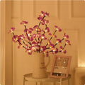 A 65cm tall pink LED phalaenopsis orchid branch light with fabric petals, powered by batteries.
