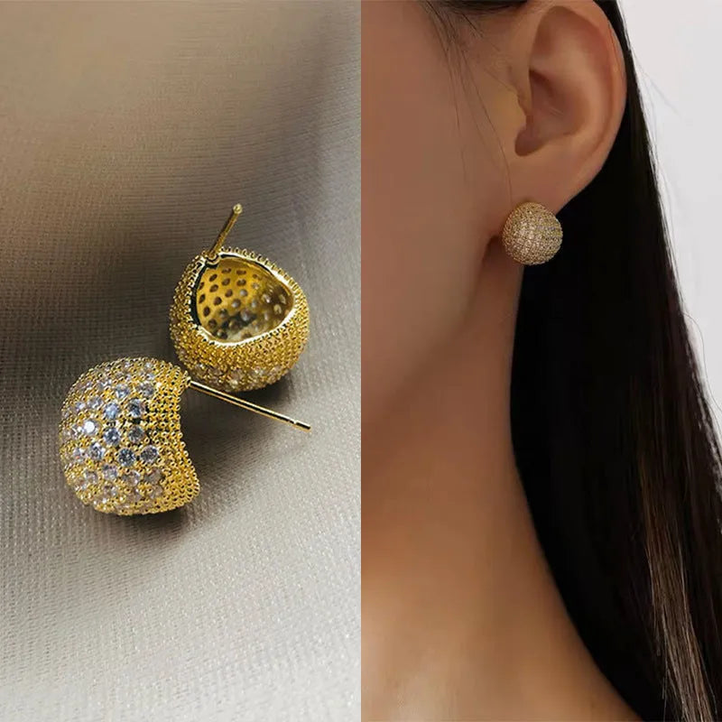 Gold and white drop-shaped geometric ear clip earrings with full diamond detailing and sphere elements