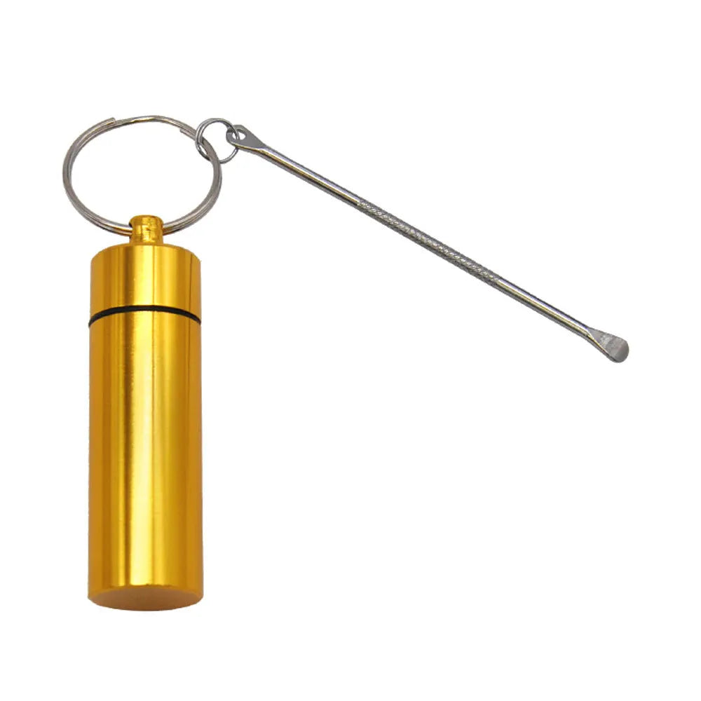 Small blue aluminium pill bottle with a silver spoon and keychain attached.