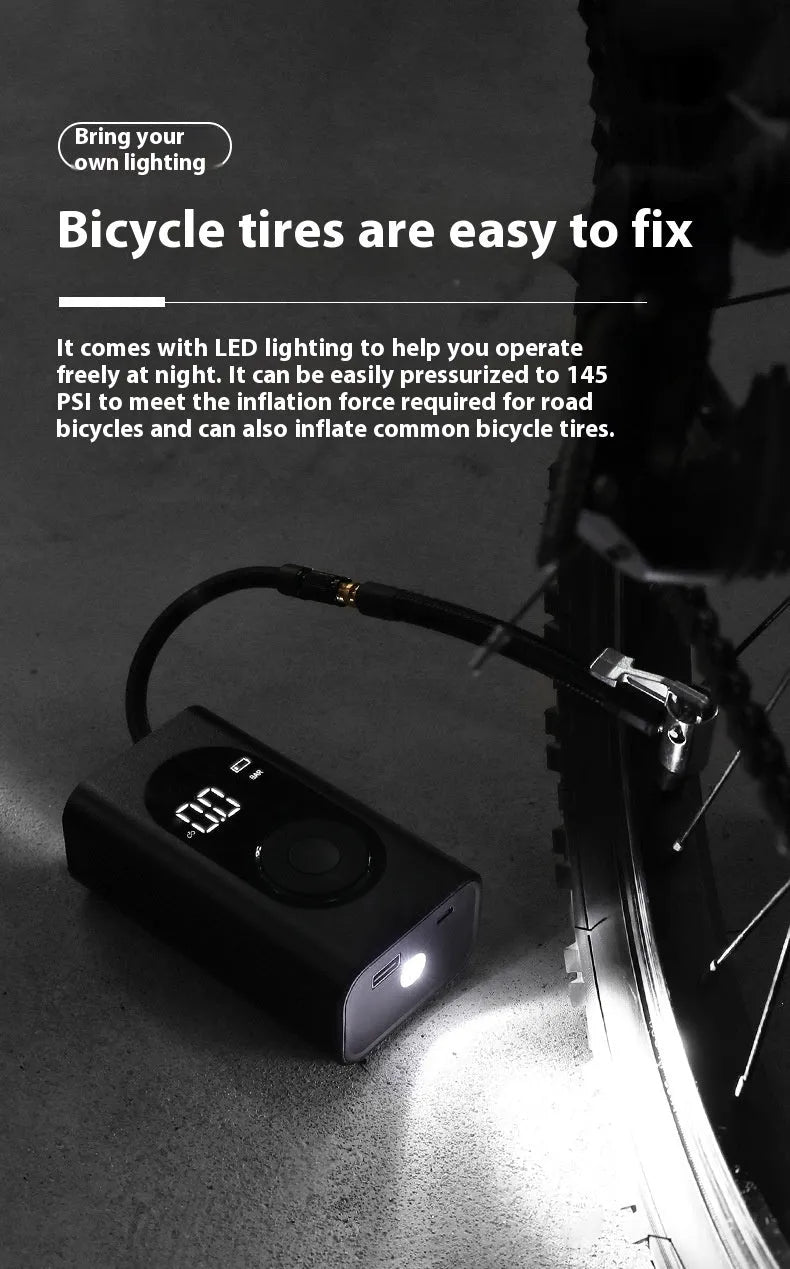 Black portable wireless tyre pump with digital display, LED flashlight, and USB cable on a grey background.