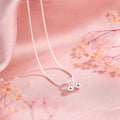 Close-up of a silver cherry pendant necklace on a textured snake bone chain, adjustable from 21cm to 50cm.