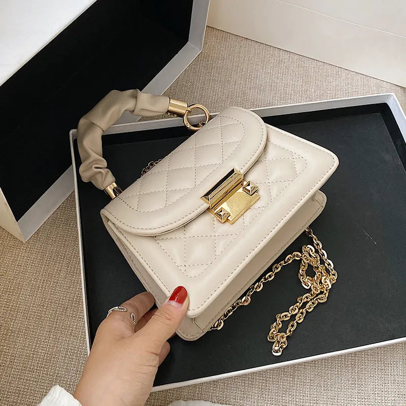 Small square purple shoulder bag with chain messenger strap showing dimensions
