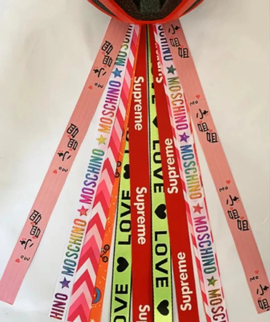 Colourful ribbon streamers attached to a child's helmet for roller skating or cycling decoration.