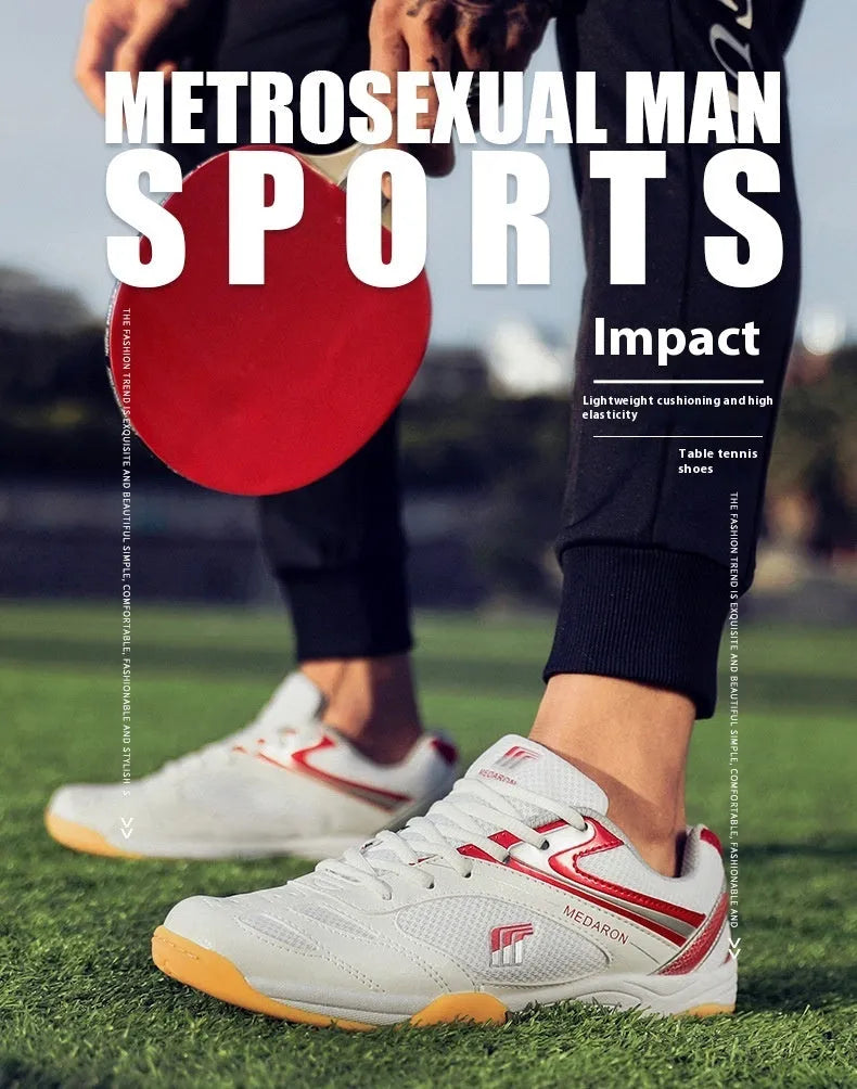 White table tennis sneakers with red accents, showing mesh panels, lace-up front, and rubber outsole.