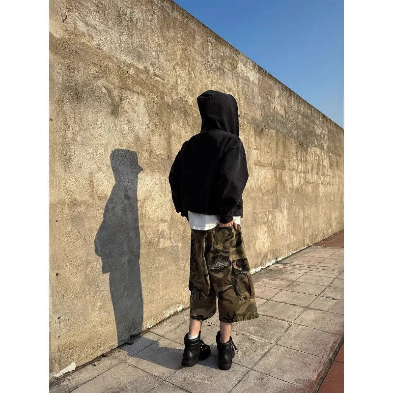 Men's retro patch ripped camouflage cropped jeans showing distressed detailing and straight leg design