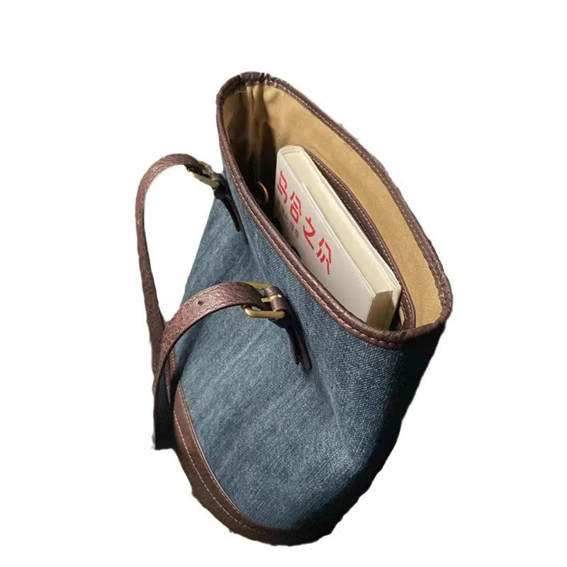 Denim wash patchwork one-shoulder bucket handbag showing front view and strap.