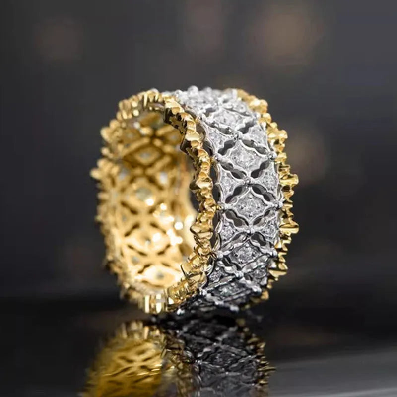 Geometric two-tone zircon ring in gold electroplated copper on a hand.