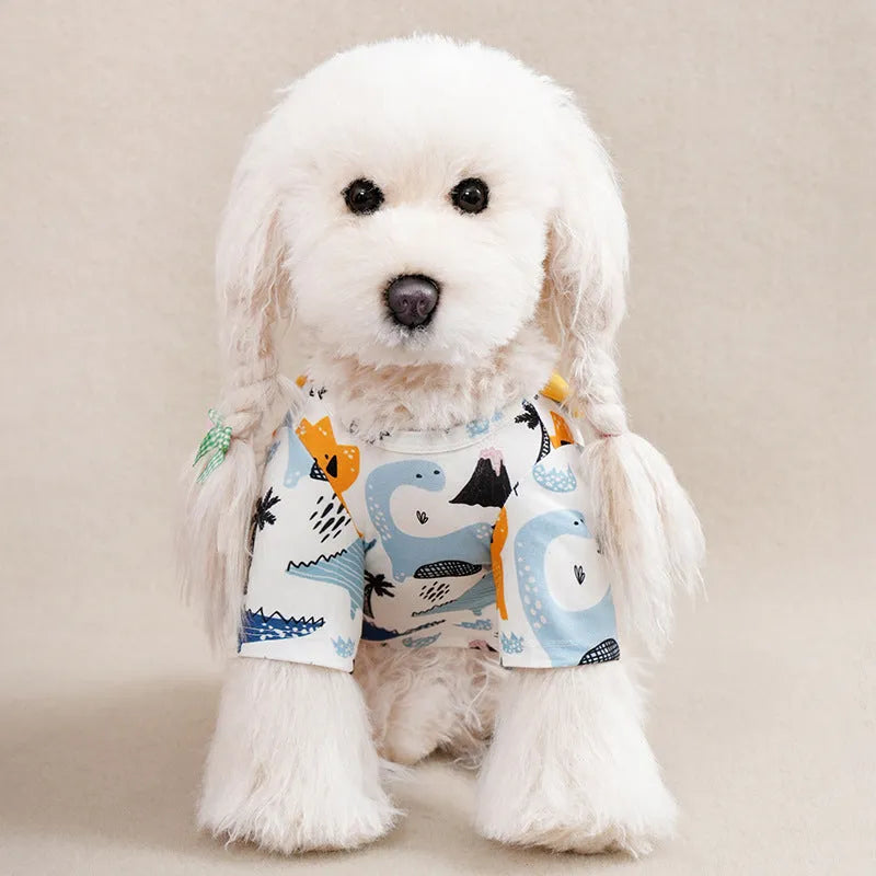 A small dog wearing a colourful full-print polyester casual T-shirt.