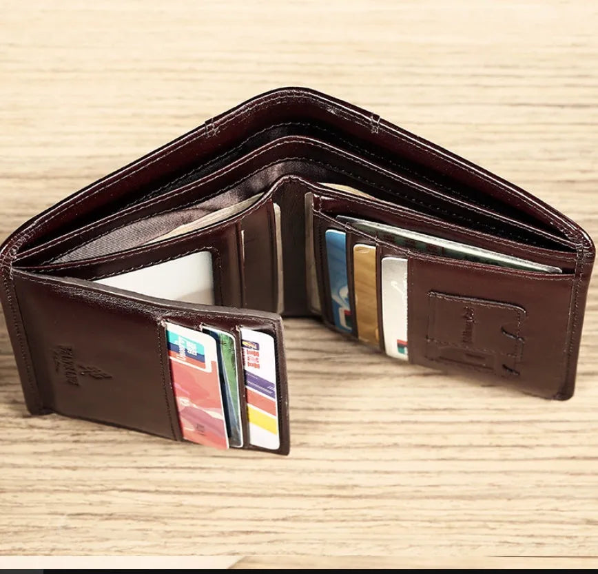 Men's black leather bifold wallet open, showing eight card slots, bill compartment, and a zip coin pocket