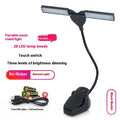Black USB rechargeable music stand lamp with 28 LEDs clipped to a metal stand.