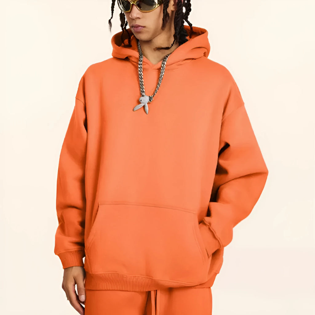 Men's loose-fit cotton terry hooded sweater in a solid colour, shown with drop-shoulder sleeves.